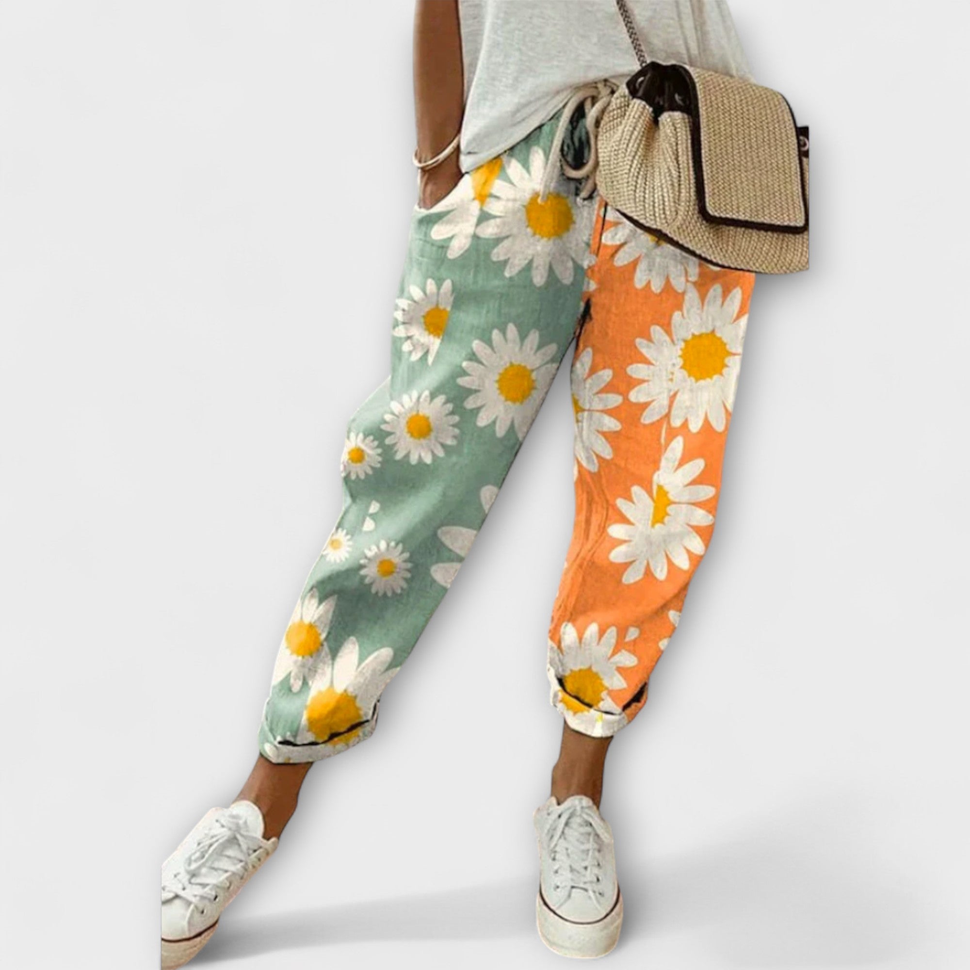 Wide-leg daisy printed pants with green and orange sections, elastic cuff hems