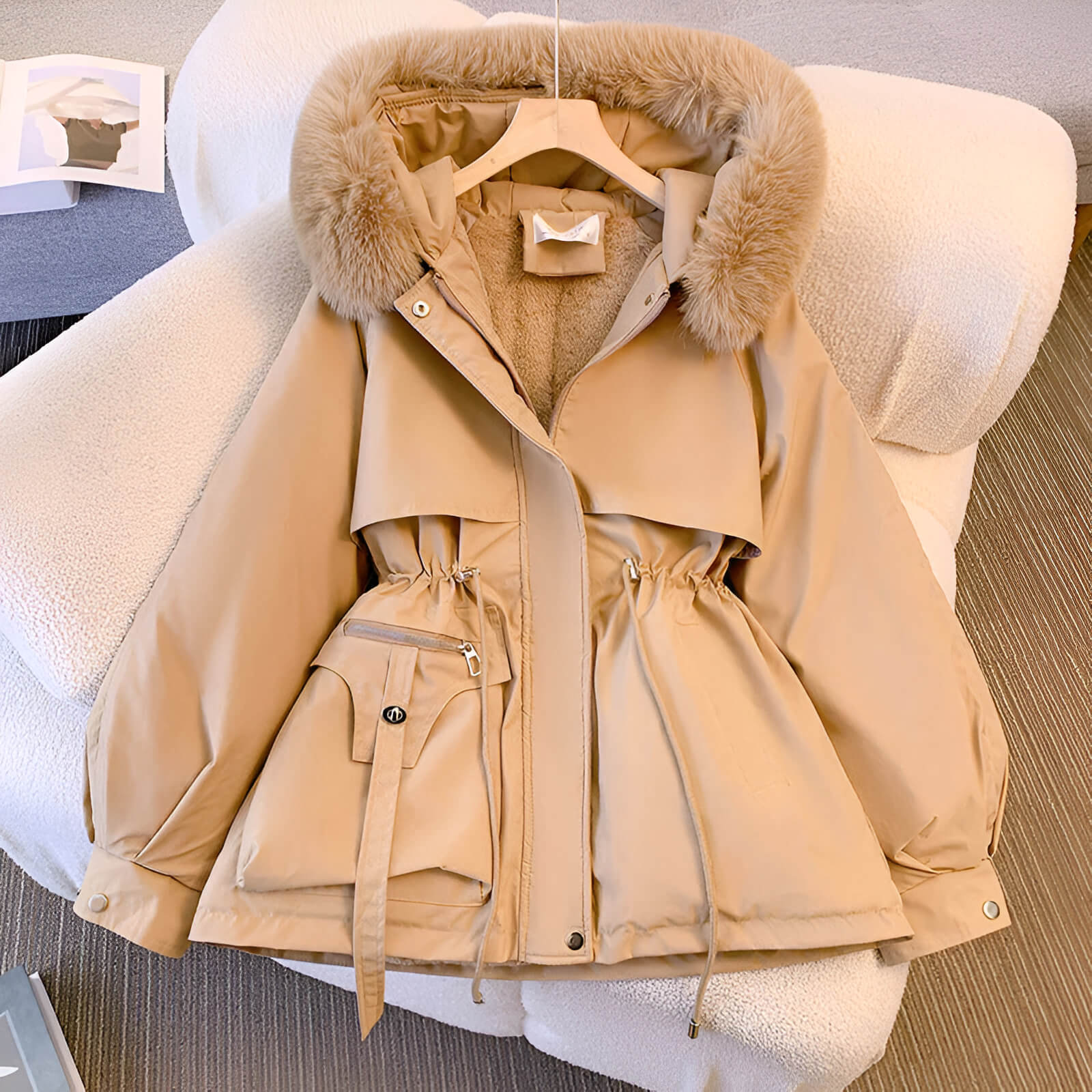 Beige hooded puffer jacket with faux-fur trim, front zipper, and drawstring waist