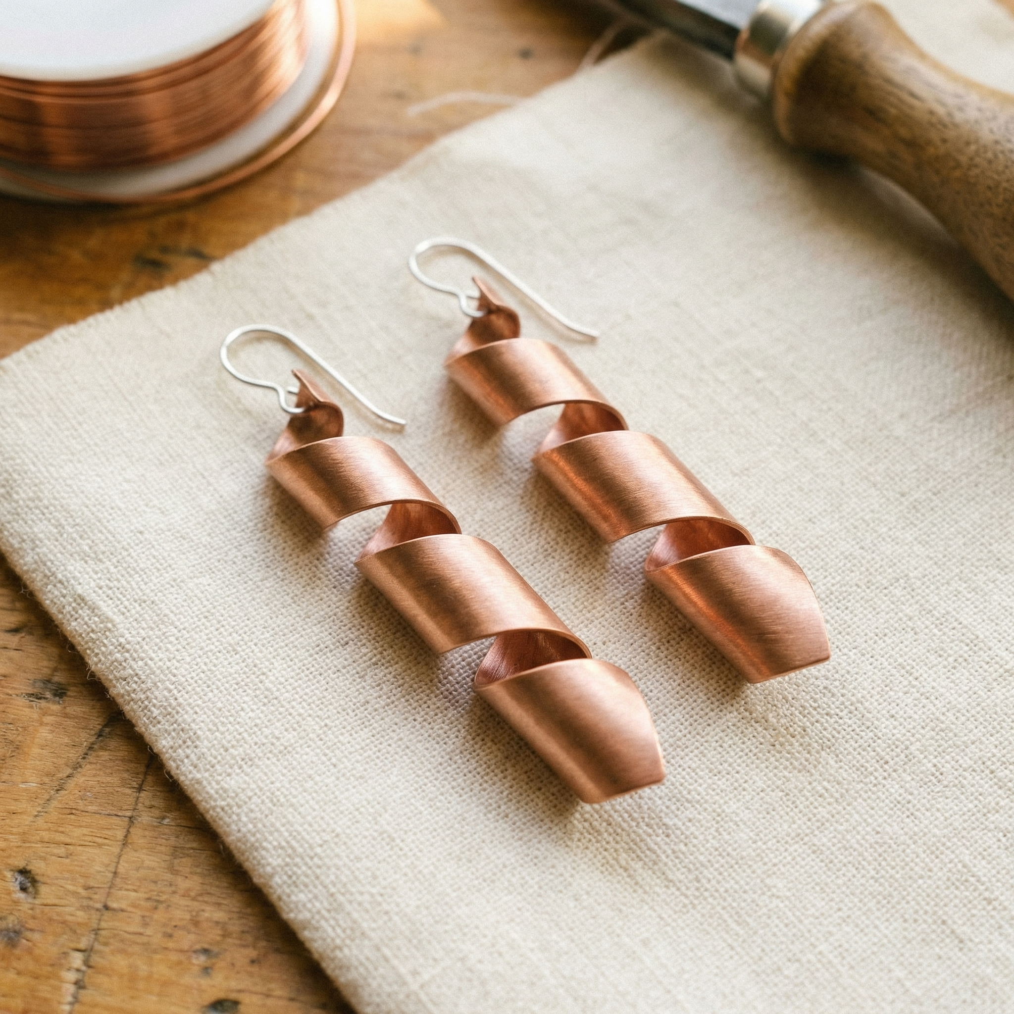Copper drop earrings with twisted ribbon design and hook backs
