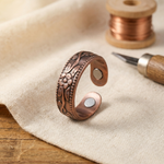 Copper petal design adjustable ring with engraved floral details and two circular cutouts