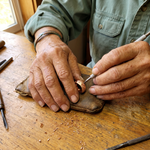 Copper hoop earring being crafted, textured round hoop with clasp