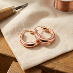 Copper hoop earrings with hinged clasp, polished copper rose tone.