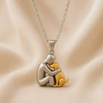Hugging cat pendant necklace, silver-tone charm with gold-tone cat and linked chain