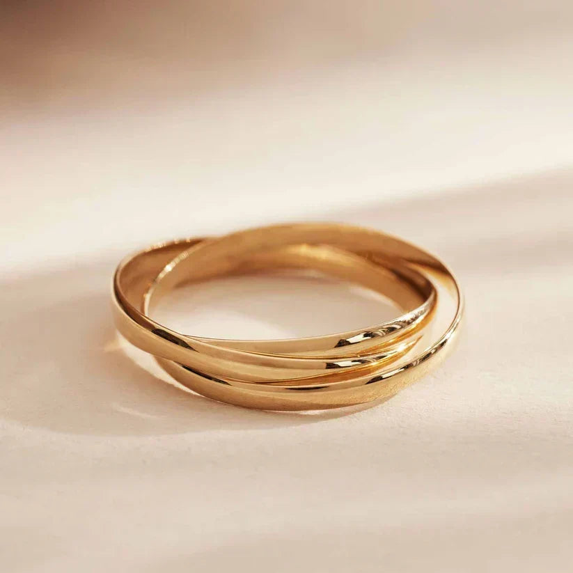 Stacked gold triple-band ring with glossy finish, side profile
