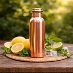 Copper water bottle with screw cap on ice and citrus slices
