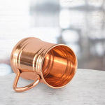 Copper mug with handle, ridged sides, angled side view