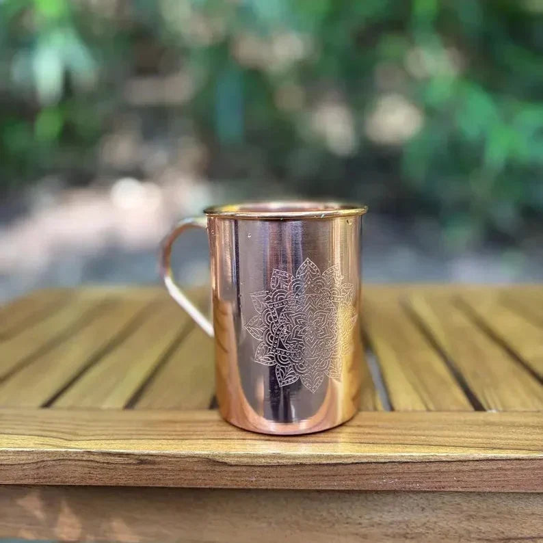 Copper 470 ml mug with mandala engraving and glossy reflective finish.