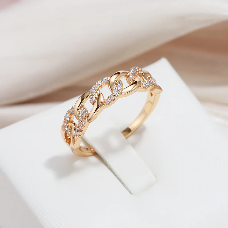 Gold-tone ring with interlinked settings and sparkling round crystals at top.