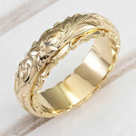 Gold-tone engraved floral band ring with antique flower motif, polished finish