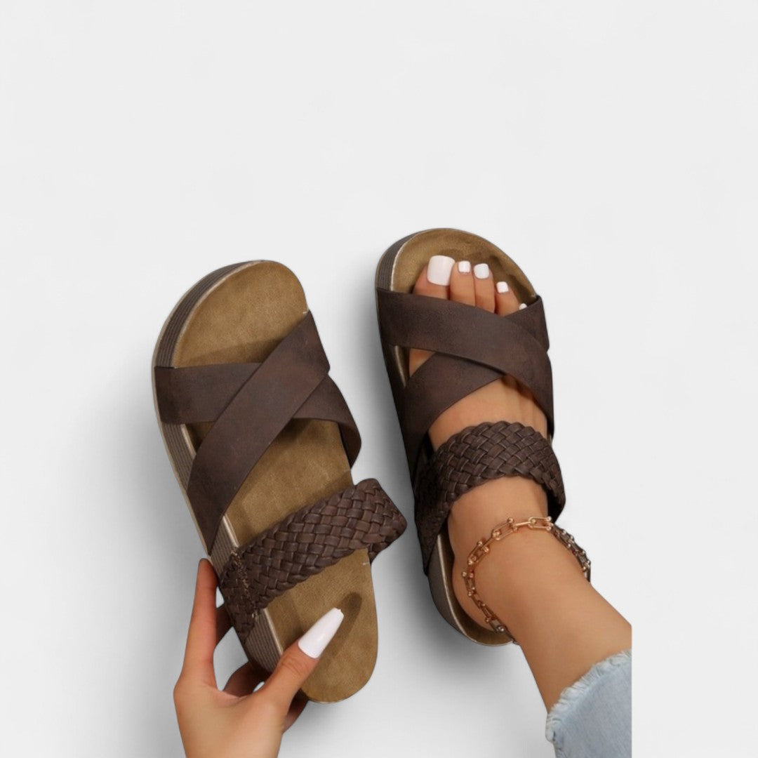 Brown comfort slide sandals with wide crisscross straps and textured platform sole