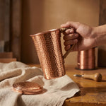 Hand-hammered copper mug with hammered texture and matching lid