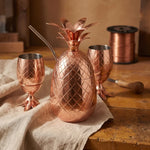 Copper pineapple-shaped cups and matching pitcher with hand-beaten diamond pattern