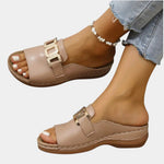 Beige orthopedic slide sandal with double gold buckle strap and open toe.