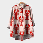 Light pink button-up blouse with red crab print, long sleeves and collar