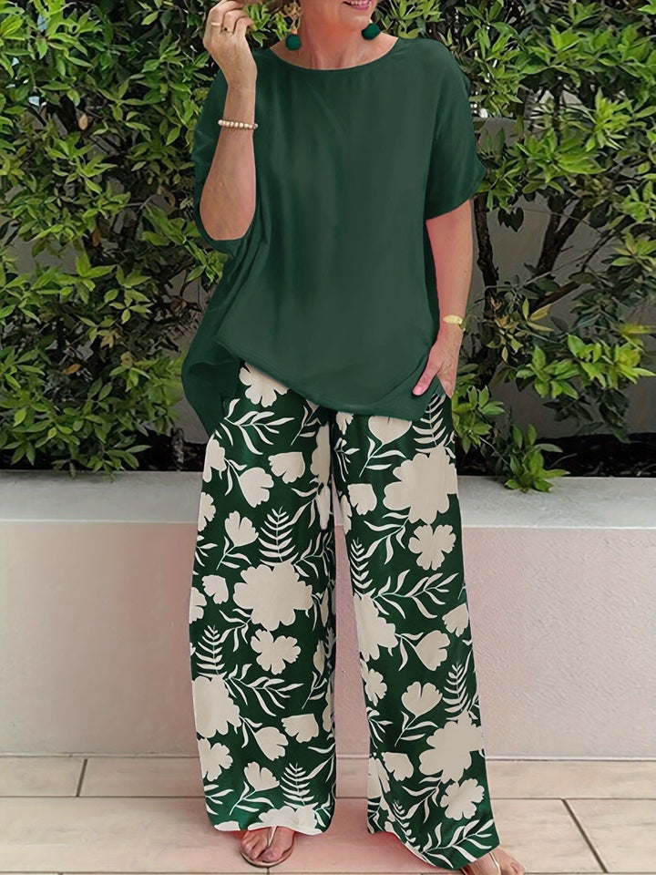 Isolde two-piece set: dark green blouse with short sleeves and green floral wide-leg pants