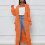 Orange long knit cardigan with open front and textured vertical ribbed pattern