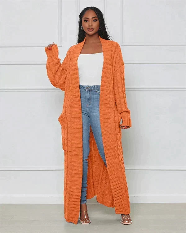 Orange long knit cardigan with open front and textured vertical ribbed pattern