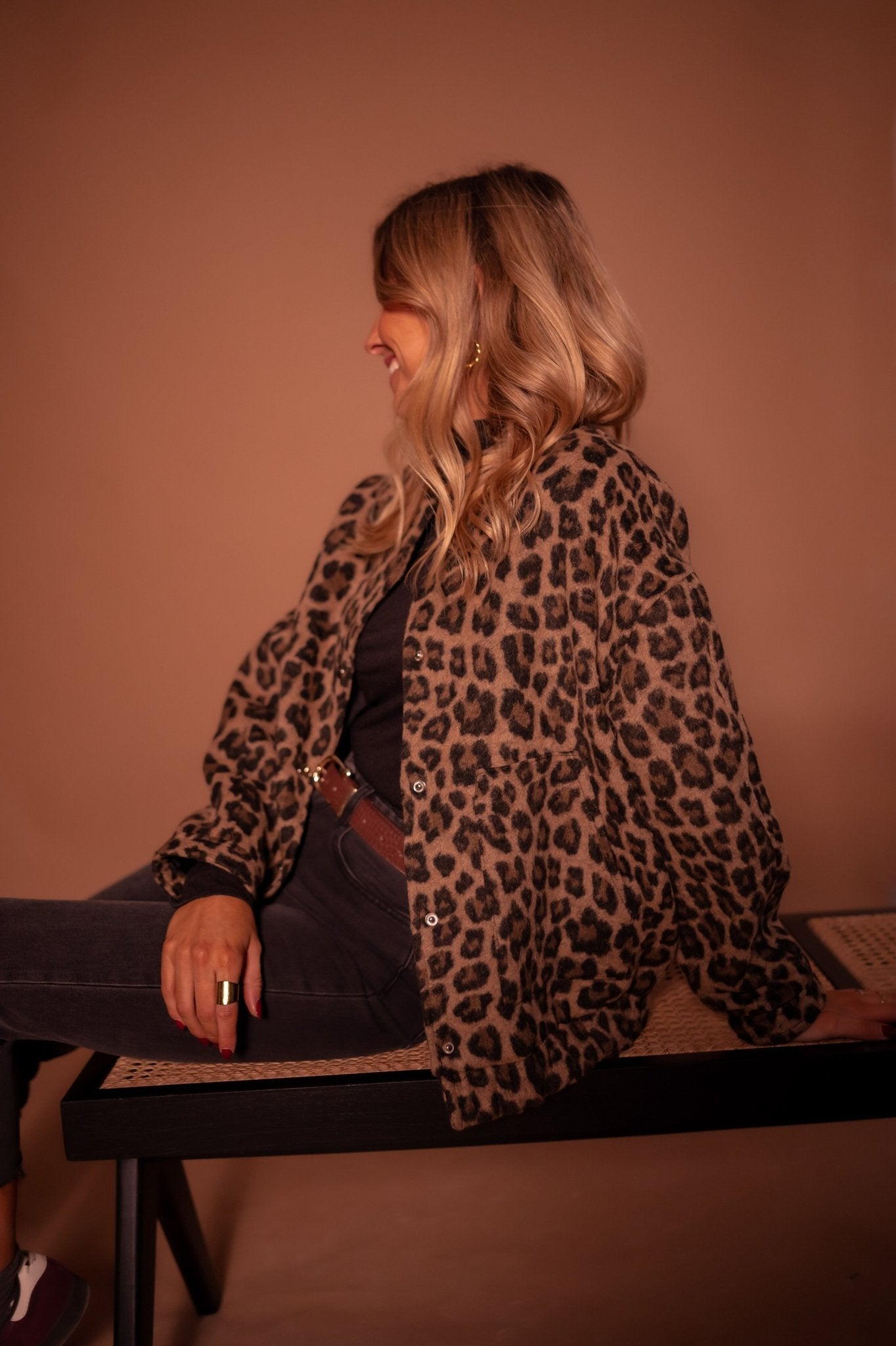 Leopard-print button-front jacket with long sleeves and curved hem