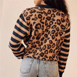 Leopard print knit cardigan sweater with navy-striped sleeves, back view