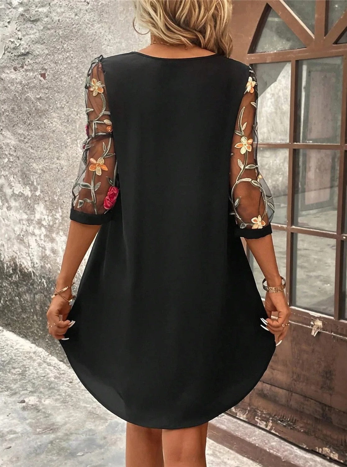 Black shift dress back view with sheer floral sleeves