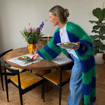 Oversized long striped cardigan with blue and green fuzzy stripes over a white top