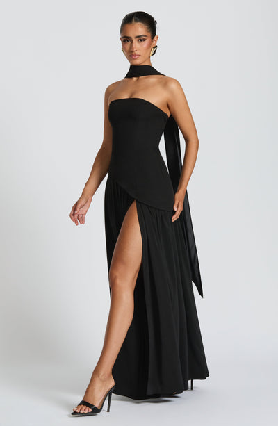 Women’s strapless black maxi dress with thigh-high side slit and long trailing panel.