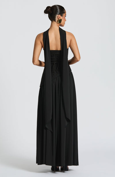 Women’s halter back maxi dress in black with open back straps and draped detail.