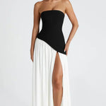 Women’s strapless maxi dress with black bodice and flowing white skirt, side slit.