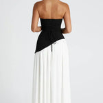 Women’s maxi dress with black lace-up bodice and white gathered skirt, back view.