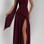 Front view of burgundy strapless maxi dress with draped side panels and leg slit