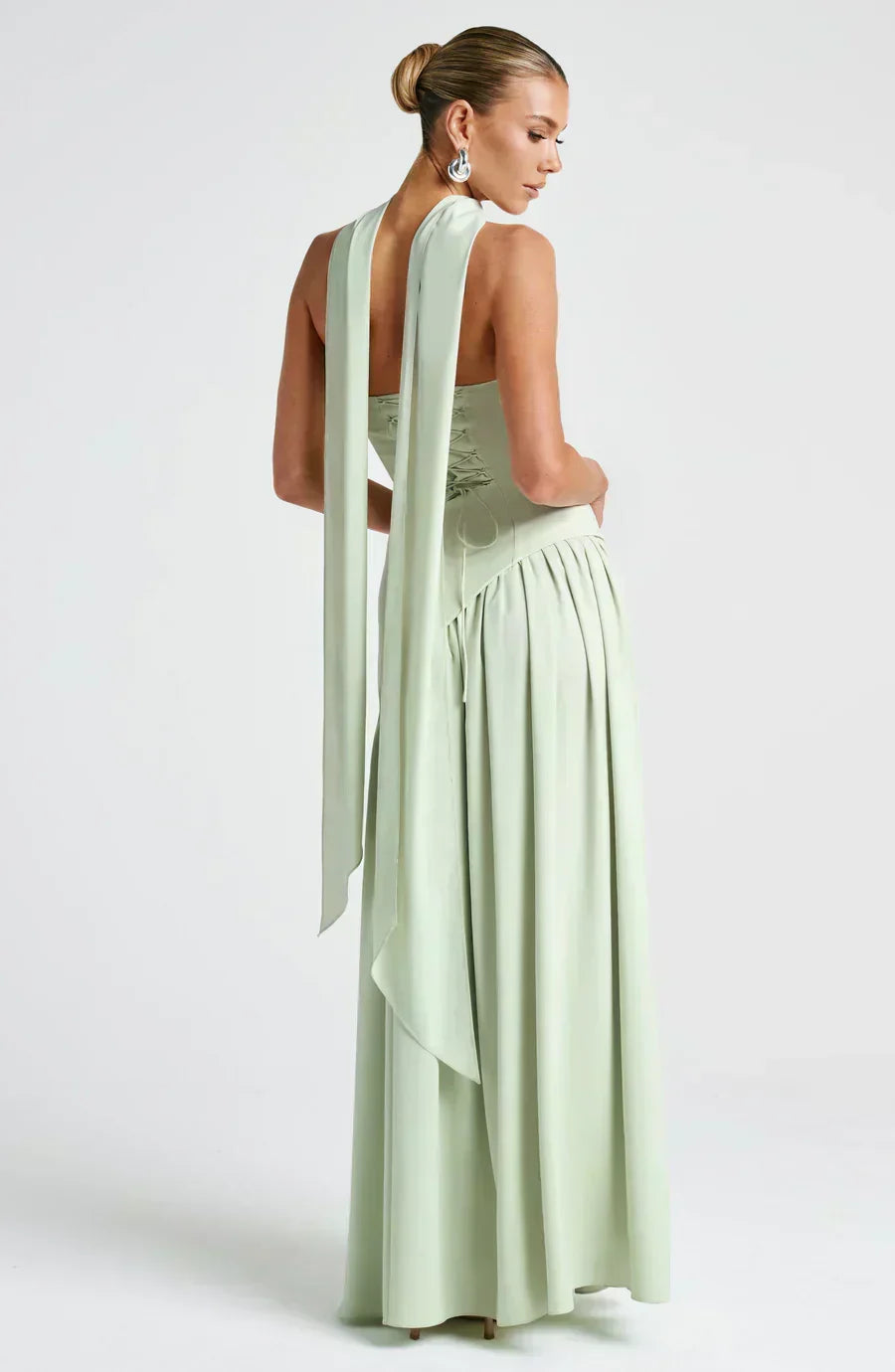 Mint green strapless maxi dress with draped back detail and flowing tiered skirt