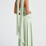 Mint green strapless maxi dress with draped back detail and flowing tiered skirt
