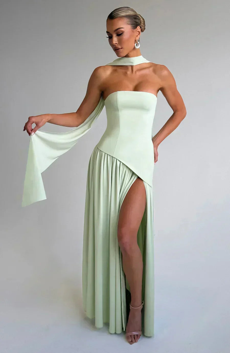 Women’s strapless maxi dress in pale mint green, with high side slit and draped cape.