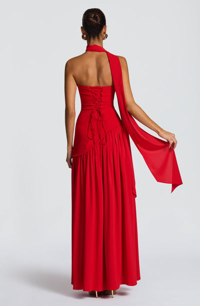Women’s backless red maxi dress with ruched bodice, open back, and trailing sash
