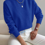 Women’s royal blue knit pullover with rolled neckline and long sleeves, relaxed fit.