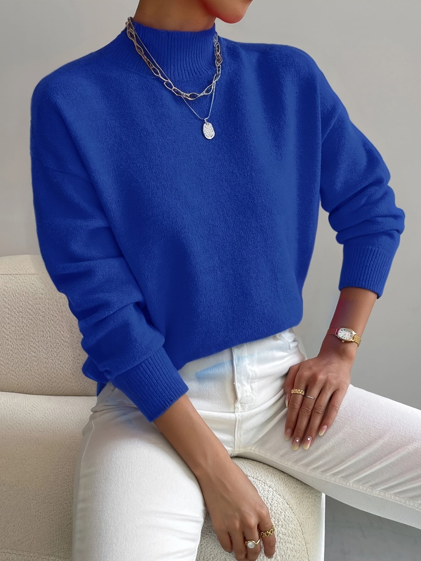 Blue knit crewneck pullover with long sleeves and ribbed cuffs