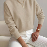 Beige knit crewneck pullover with long sleeves and ribbed cuffs