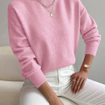 Light pink knit crewneck pullover with long sleeves and ribbed cuffs