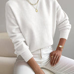 Women’s white knit pullover with rolled neckline and long sleeves, relaxed fit.
