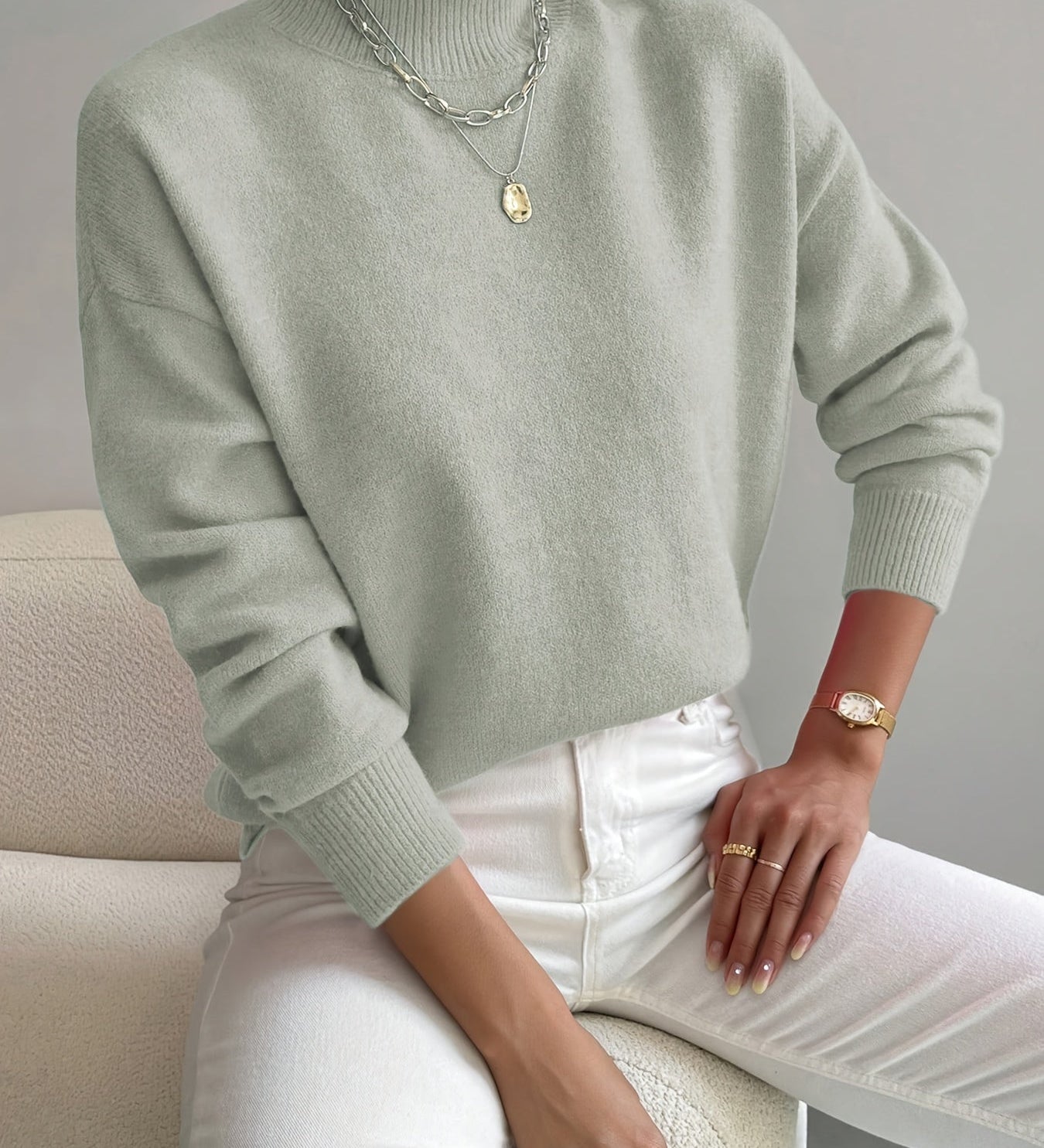 Light green knit crewneck pullover with long sleeves and ribbed cuffs