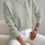 Light green knit crewneck pullover with long sleeves and ribbed cuffs