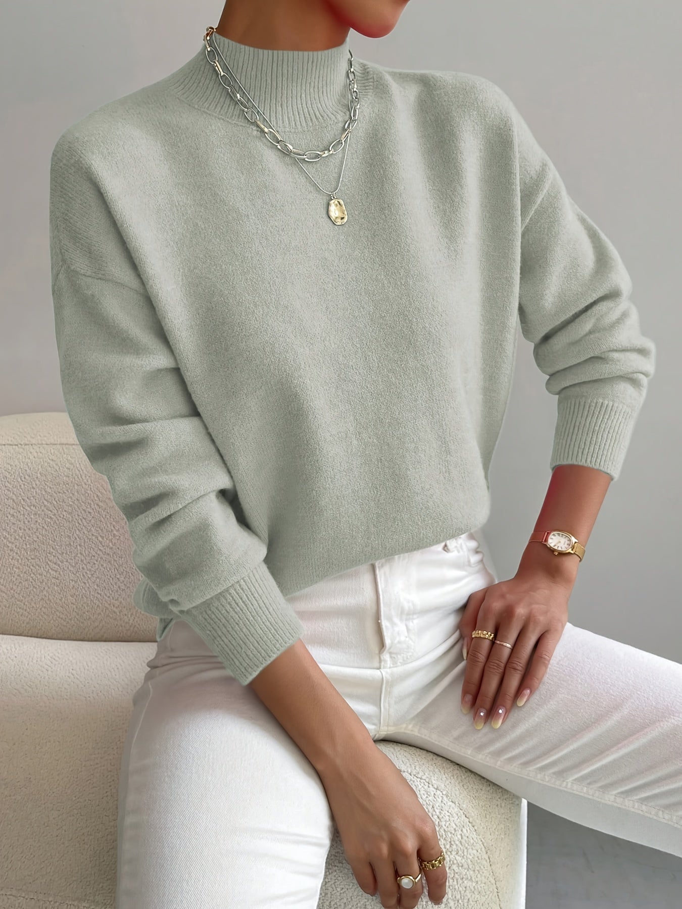 Light green knit crewneck pullover with long sleeves and ribbed cuffs
