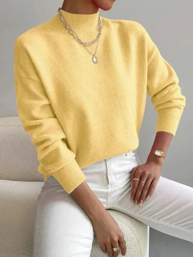 Yellow knit crewneck pullover with long sleeves and ribbed cuffs