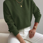 Dark green knit crewneck pullover with long sleeves and ribbed cuffs