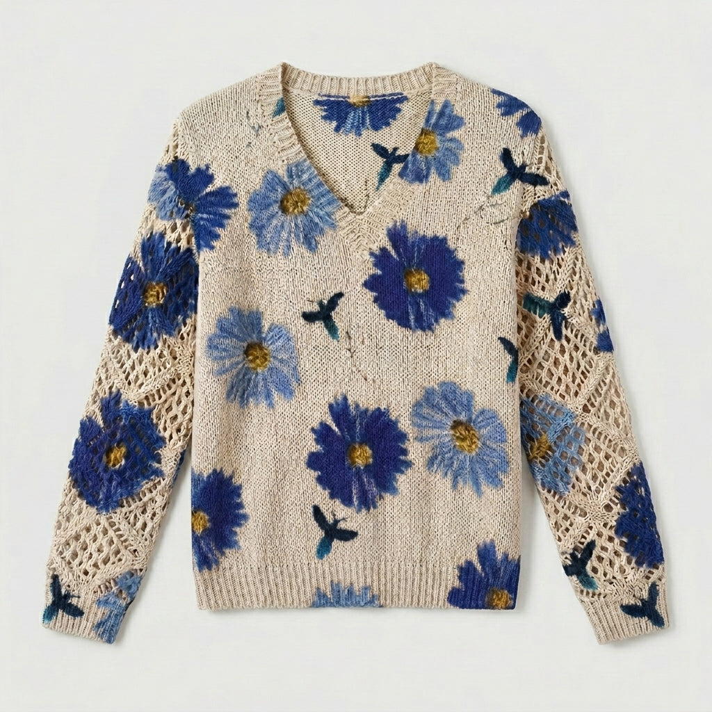 Cream knit floral pullover sweater with blue flowers and crochet-knit sleeve panels