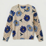 Cream knit floral pullover sweater with blue flowers and crochet-knit sleeve panels