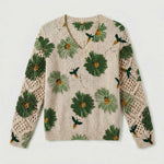 Cream knit floral pullover sweater with green flowers and crochet-knit sleeve panels
