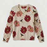 Cream knit floral pullover sweater with red flowers and crochet-knit sleeve panels