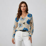 Cream knit floral pullover with blue flowers, V-neck and button; crochet-knit sleeves