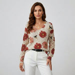 Cream knit floral pullover with red flowers, V-neck and button; crochet-knit sleeves